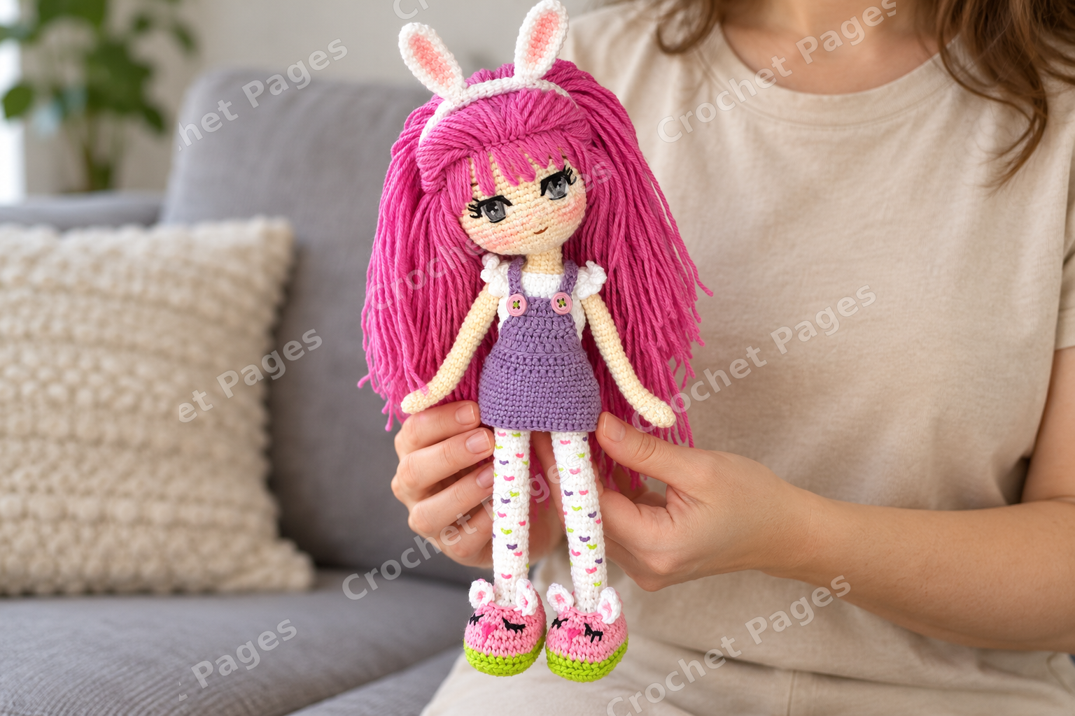 Crocheted girl doll with long pink hair, bunny ears and a purple pinafore; a closer view of the yarn sample.
