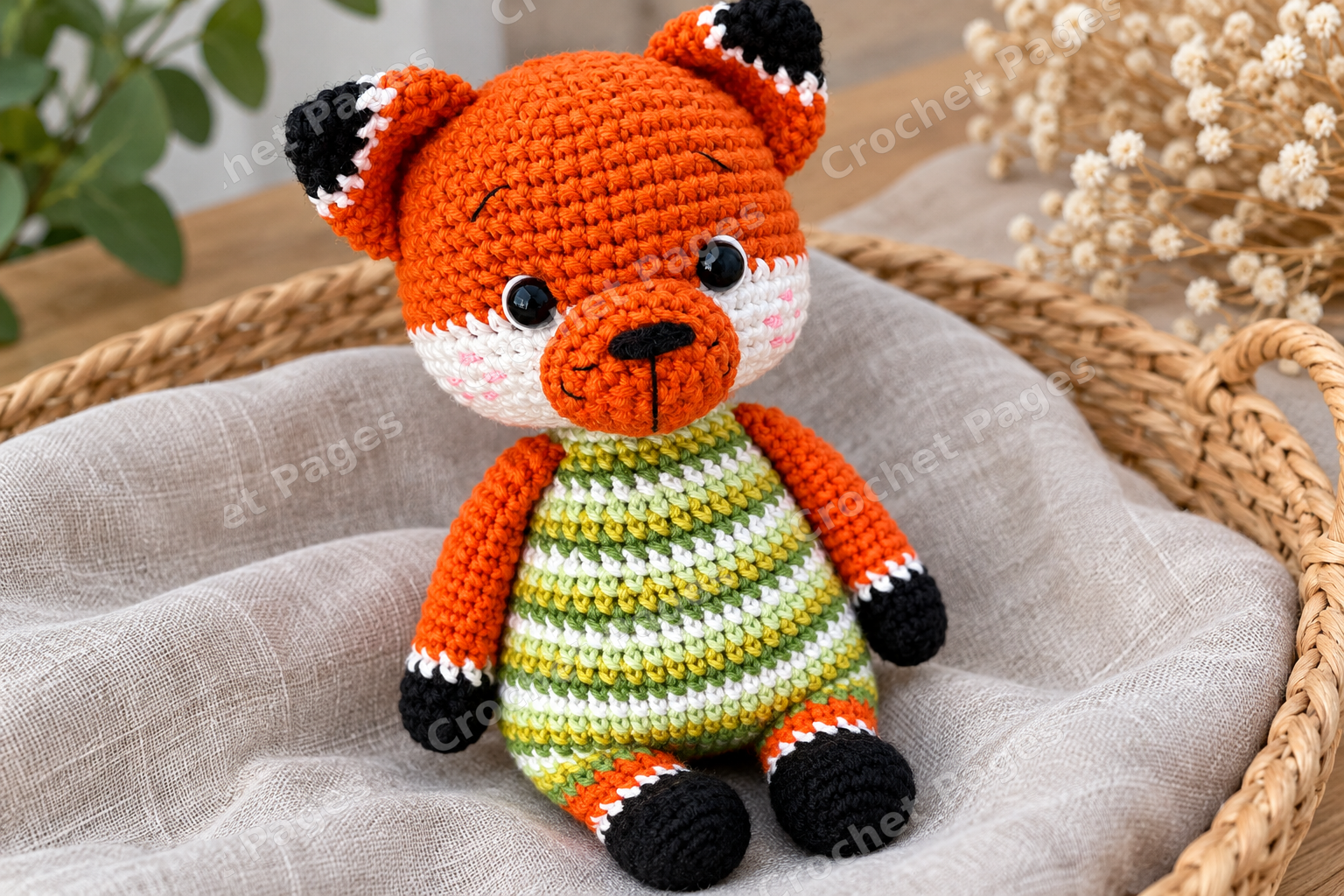 Crocheted fox cub with a green striped body and white muzzle; another view of the finished crochet sample.