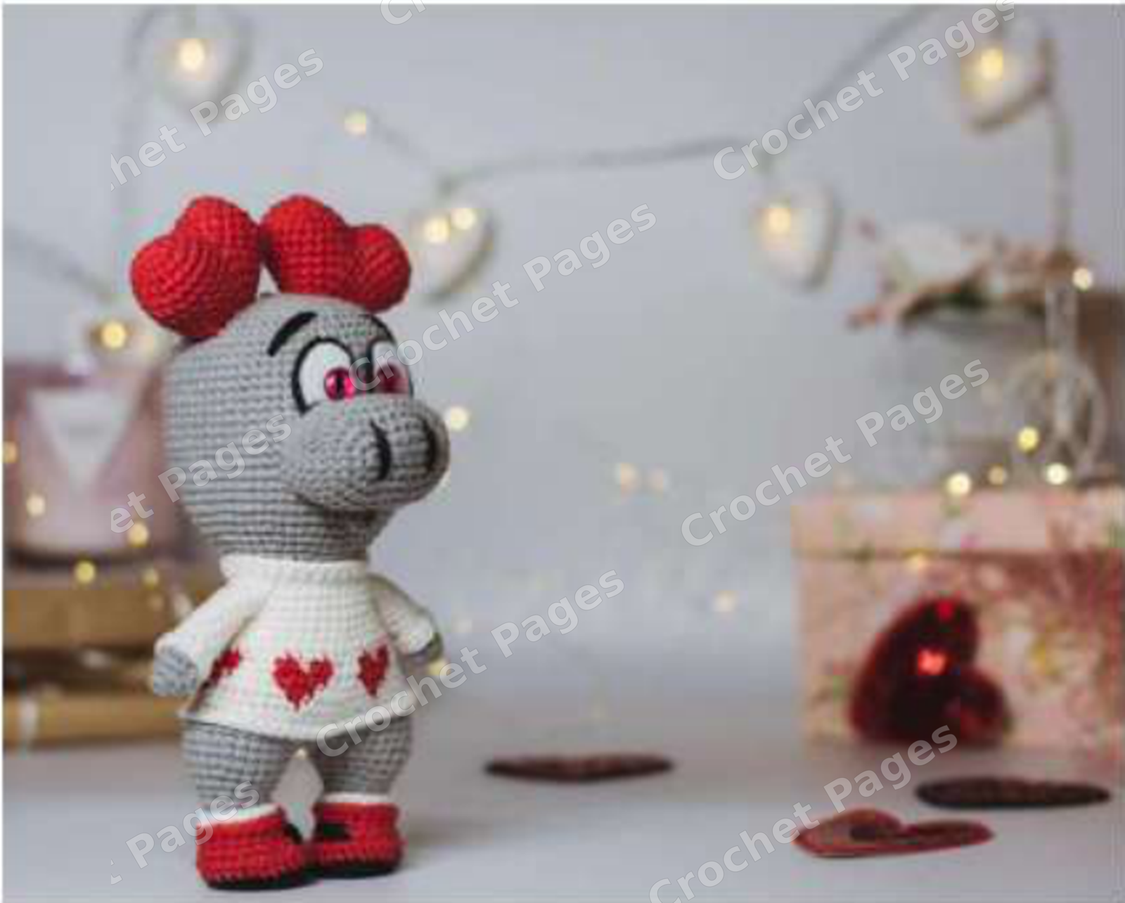 Crochet a long-limbed love monster with a sculpted muzzle, contrasting paws and a red heart. Includes colorwork chart and construction photos. Detail of the crocheted project.