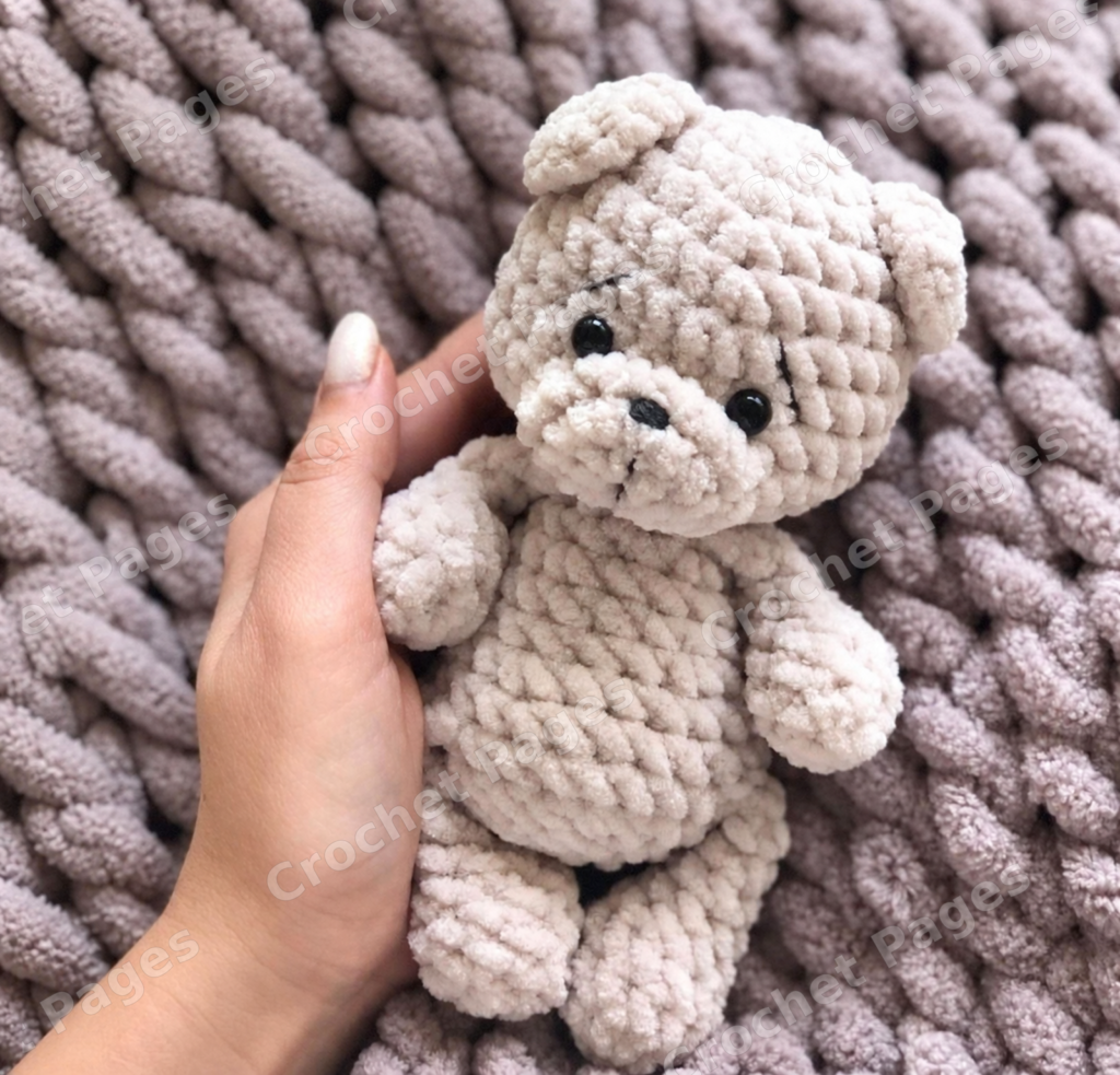 Crochet a little bear with rounded ears, a textured contrasting muzzle and short limbs.