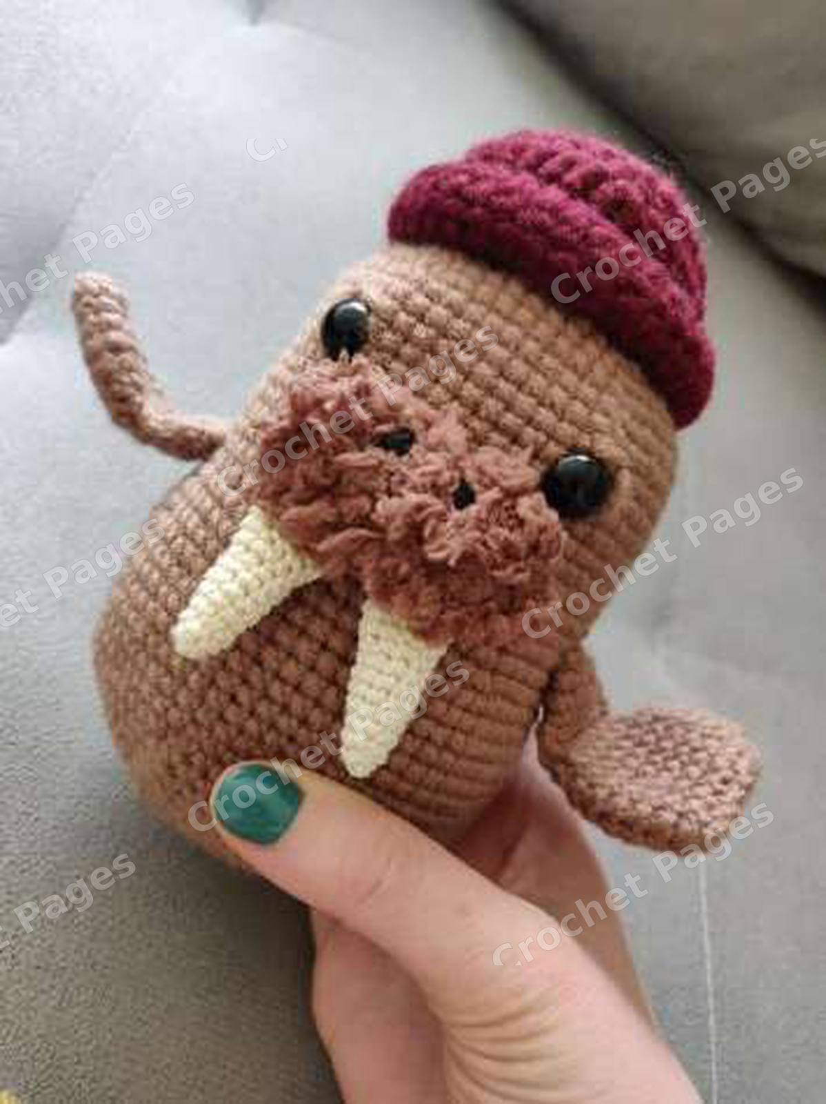Make a rounded walrus with a fuzzy muzzle, curved tusks, shaped side flippers, joined tail flippers and a turned-up burgundy hat. Finished-project view.