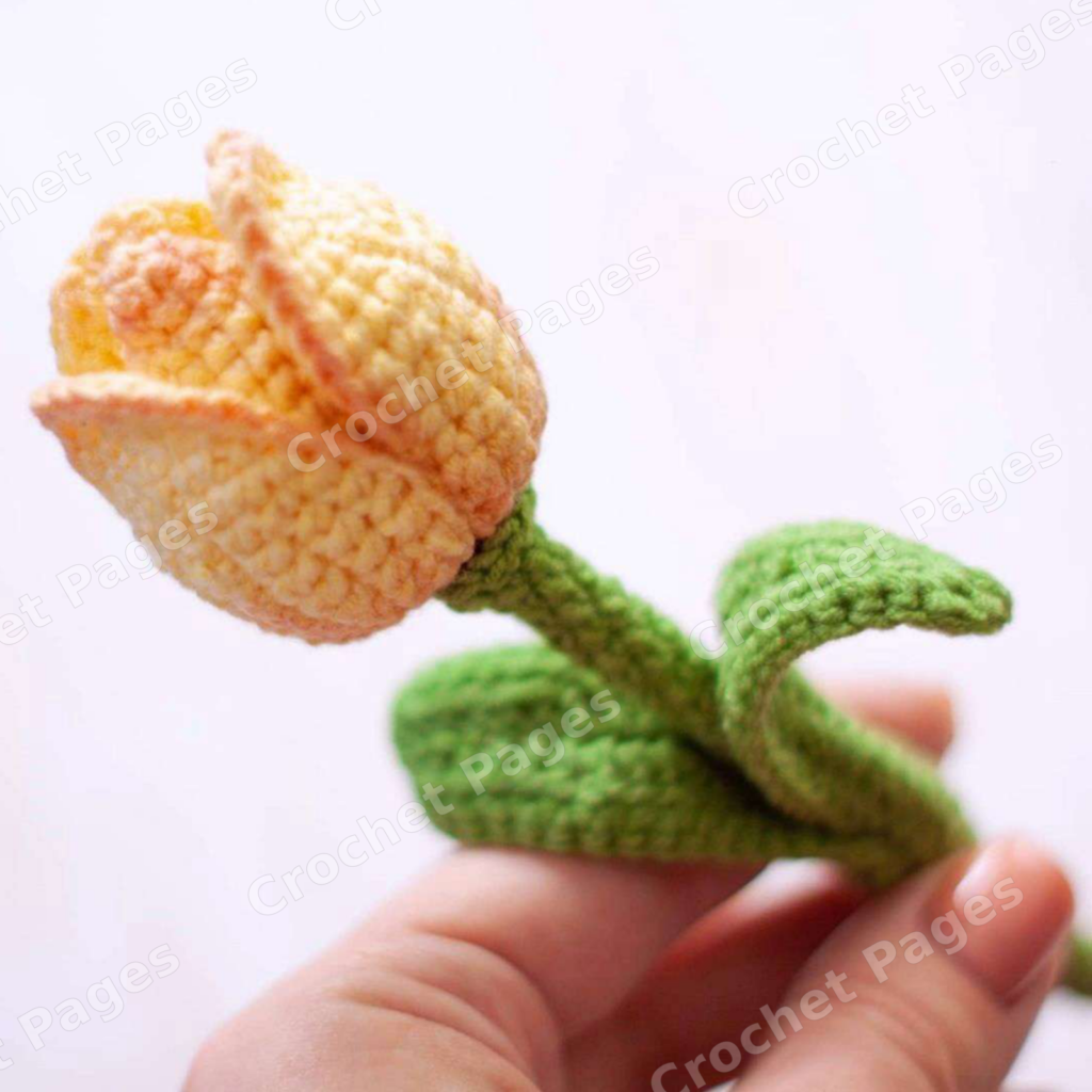 Crochet a layered tulip with three shaped petals, a stuffed center, a supported stem and two leaves. Includes flower assembly photos. Finished-project view.